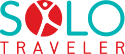 Logo reading "Solo Traveler" with the word "Solo" in teal and "Traveler" in red. The "O" in "Solo" includes a stylized red figure with arms raised.