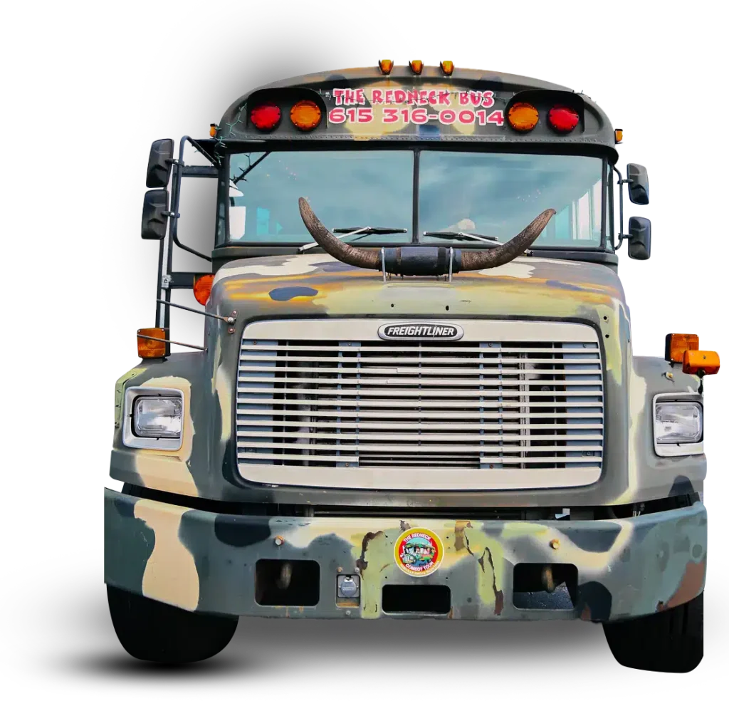 Front view of a camo-painted bus with bull horns on the hood and a red sign reading "THE REDNECK BUS 615 316-0014" above the windshield.