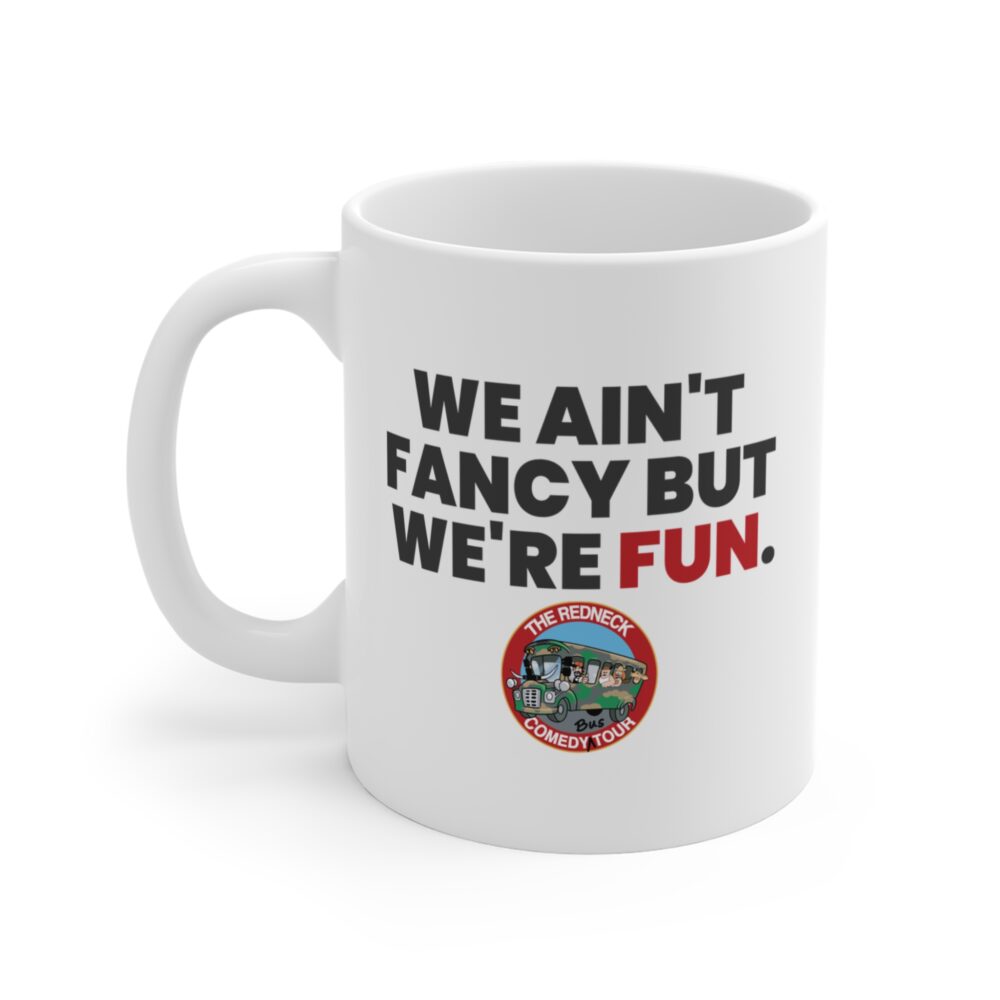 The We Ain't Fancy Coffee Mug - White features "WE AIN'T FANCY BUT WE'RE FUN." and The Redneck Comedy Tour logo with a cartoon bus at the bottom.