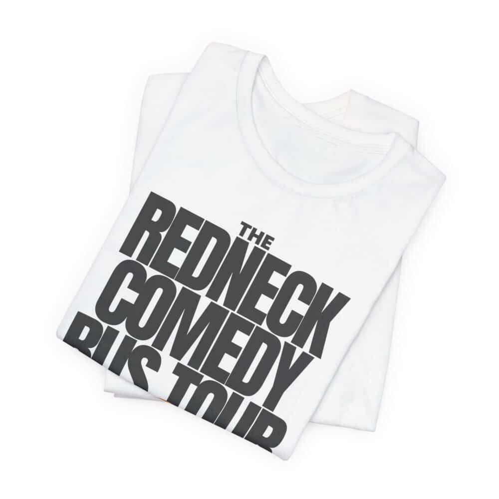 The Redneck Comedy Bus Tour T-shirt is a folded white tee with bold black text on the front that reads "THE REDNECK COMEDY BUS TOUR.