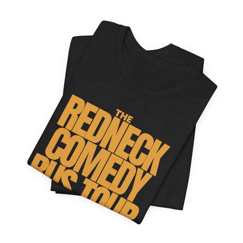 The Redneck Comedy Bus Tour Tshirt is a black T-shirt featuring bold yellow "The Redneck Comedy Bus Tour" text on the front, shown folded.