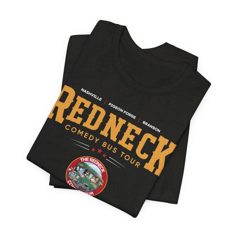 The Redneck Comedy Bus Tour Tshirt is a folded black tee featuring "Redneck Comedy Bus Tour" and city names, plus a colorful cartoon bus logo at the bottom.