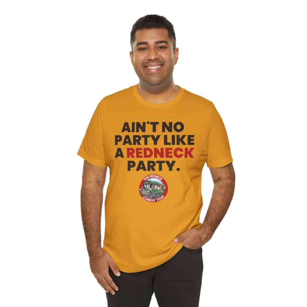 A smiling person wears the "Ain't No Party - Redneck Tshirt" in mustard yellow, featuring the text "AIN'T NO PARTY LIKE A REDNECK PARTY" and a circular logo on the front.