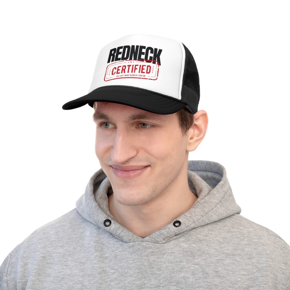 Man wearing a gray hoodie and the Redneck Certified Trucker Hat, which features a bold "REDNECK CERTIFIED" text with a red stamp-style graphic on the front.